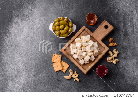 White feta, tofu, or mozzarella cheese cubes with herbs. White mozzarella cheese White feta, tofu, or mozzarella cheese cubes with herbs. White mozzarella cheese 140748794