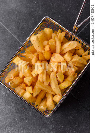 Golden French fries fried with salt and spices, unhealthy takeaway food. French fries Golden French fries fried with salt and spices, unhealthy takeaway food. French fries 140748801