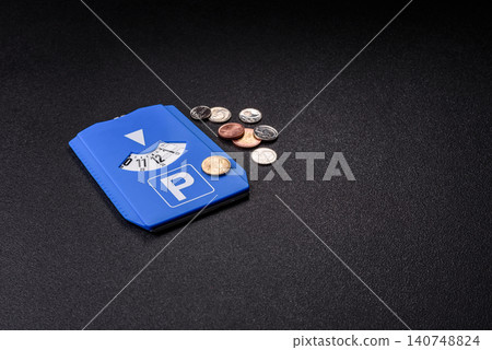 A parking disc, permit, or ticket for measuring time and paying municipal services. A parking disc A parking disc, permit, or ticket for measuring time and paying municipal services. A parking disc 140748824