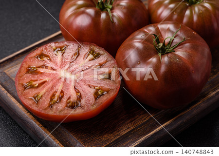Fresh pink and black tomatoes adora or kumato as an ingredient for a salad. Tomatoes adora or kumato Fresh pink and black tomatoes adora or kumato as an ingredient for a salad. Tomatoes adora or kumato 140748843