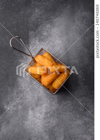 Mozzarella cheese sticks, breaded and fried with salt and tomato sauce, for takeaway. Cheese sticks Mozzarella cheese sticks, breaded and fried with salt and tomato sauce, for takeaway. Cheese sticks 140748869