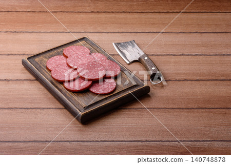 Slices of smoked salami or pepperoni for making sandwiches or pizza at home. Sausage slices 140748878