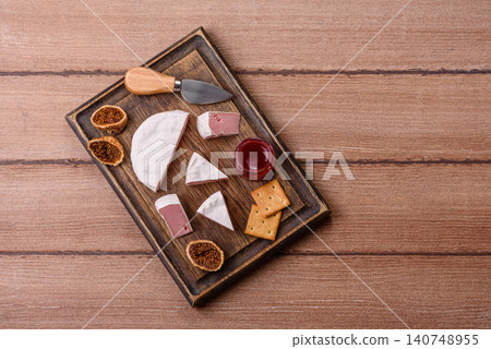 Pink Brie or Camembert cheese with honey, jam, figs, and crackers. Brie cheese Pink Brie or Camembert cheese with honey, jam, figs, and crackers. Brie cheese 140748955