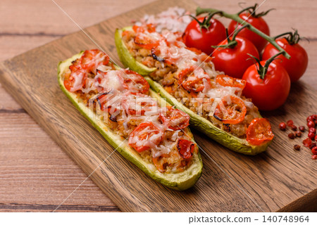 Baked zucchini half with minced meat, tomatoes, cheese, salt, and spices. Zucchini with minced meat Baked zucchini half with minced meat, tomatoes, cheese, salt, and spices. Zucchini with minced meat 140748964
