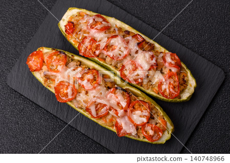 Baked zucchini half with minced meat, tomatoes, cheese, salt, and spices. Zucchini with minced meat Baked zucchini half with minced meat, tomatoes, cheese, salt, and spices. Zucchini with minced meat 140748966