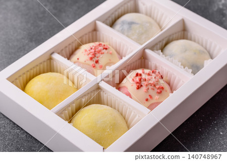 Japanese sweet frozen mochi with rice dough, fruit, and chocolate filling. Japanese mochi Japanese sweet frozen mochi with rice dough, fruit, and chocolate filling. Japanese mochi 140748967