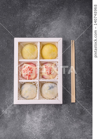 Japanese sweet frozen mochi with rice dough, fruit, and chocolate filling. Japanese mochi Japanese sweet frozen mochi with rice dough, fruit, and chocolate filling. Japanese mochi 140748968