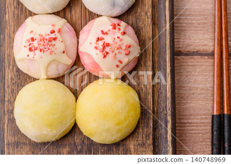 Japanese sweet frozen mochi with rice dough, fruit, and chocolate filling. Japanese mochi Japanese sweet frozen mochi with rice dough, fruit, and chocolate filling. Japanese mochi 140748969