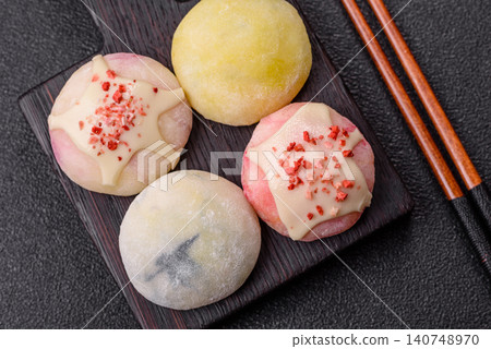 Japanese sweet frozen mochi with rice dough, fruit, and chocolate filling. Japanese mochi Japanese sweet frozen mochi with rice dough, fruit, and chocolate filling. Japanese mochi 140748970