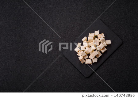 White feta, tofu, or mozzarella cheese cubes with herbs. White mozzarella cheese White feta, tofu, or mozzarella cheese cubes with herbs. White mozzarella cheese 140748986