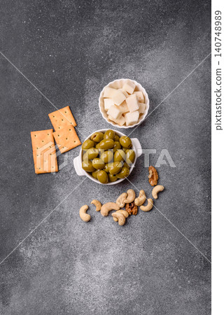 Whole green olives without pits in a bowl as an ingredient for cooking at home. Green olives Whole green olives without pits in a bowl as an ingredient for cooking at home. Green olives 140748989