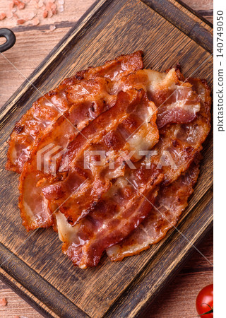 Fried fresh bacon slices with layers of meat or prosciutto with salt and spices. Fried bacon Fried fresh bacon slices with layers of meat or prosciutto with salt and spices. Fried bacon 140749050