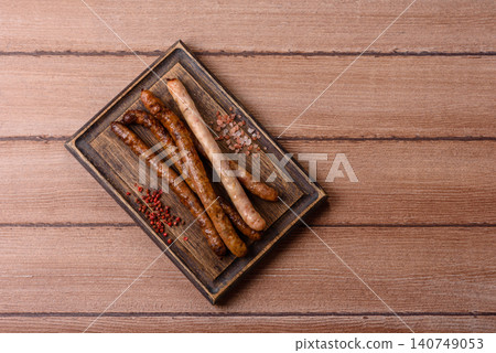 Thin chicken or pork sausages grilled or barbecued. Grilled sausages 140749053