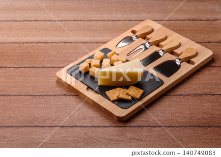 Aged cheese in a triangular block with jam, figs, and nuts. Aged cheese Aged cheese in a triangular block with jam, figs, and nuts. Aged cheese 140749083