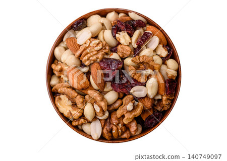 A mix of pistachios, hazelnuts, walnuts, peanuts, dried berries, and fruits. A mix of nuts 140749097