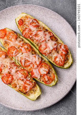 Baked zucchini half with minced meat, tomatoes, cheese, salt, and spices. Zucchini with minced meat Baked zucchini half with minced meat, tomatoes, cheese, salt, and spices. Zucchini with minced meat 140749101