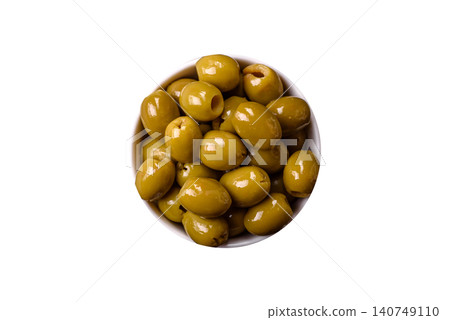 Whole green olives without pits in a bowl as an ingredient for cooking at home. Green olives Whole green olives without pits in a bowl as an ingredient for cooking at home. Green olives 140749110