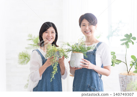 Female shop assistant at a gardening shop Female shop assistant at a gardening shop 140749307