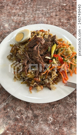 Traditional Beef Plov Served with Fresh Pickled Salad and Boiled Egg 140749440