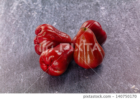 Red rose apples on textured gray surface Red rose apples on textured gray surface 140750170