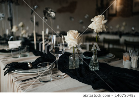 Top view of luxury dark and moody table decor for a fine dining event or reception Top view of luxury dark and moody table decor for a fine dining event or reception 140750482
