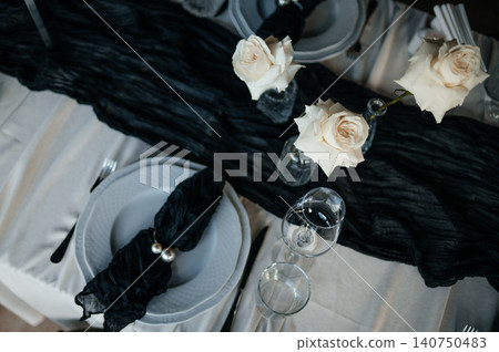 Top view of luxury dark and moody table decor for a fine dining event or reception 140750483