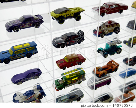 Carefully organized tiny vehicle arrangements displayed beneath glass grid ceiling with lighting Carefully organized tiny vehicle arrangements displayed beneath glass grid ceiling with lighting 140750573