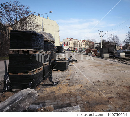 Big construction site. Excavated urban trench with manhole and paved surroundings Big construction site. Excavated urban trench with manhole and paved surroundings 140750634