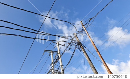 Messy Power Lines and Electric Poles Under Blue Sky Messy Power Lines and Electric Poles Under Blue Sky 140750648
