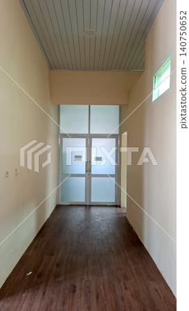 Long Empty Hallway Leading to Glass Entrance Long Empty Hallway Leading to Glass Entrance 140750652