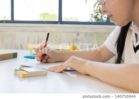 Hands of a student studying for an exam Hands of a student studying for an exam 140750844