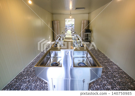 Row of Clean Stainless Steel Sinks and Faucets in a Public Facility Row of Clean Stainless Steel Sinks and Faucets in a Public Facility 140750985