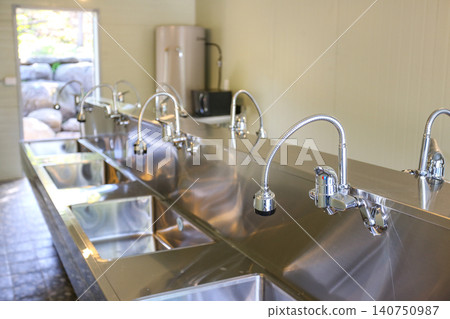 Row of Clean Stainless Steel Sinks and Faucets in a Public Facility Row of Clean Stainless Steel Sinks and Faucets in a Public Facility 140750987