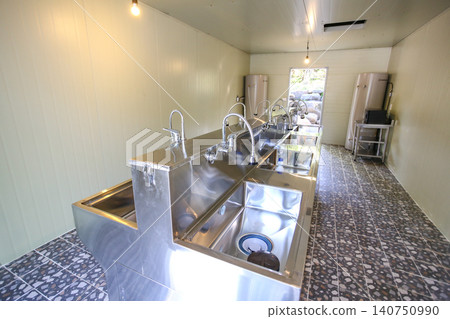 Row of Clean Stainless Steel Sinks and Faucets in a Public Facility Row of Clean Stainless Steel Sinks and Faucets in a Public Facility 140750990