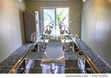 Row of Clean Stainless Steel Sinks and Faucets in a Public Facility Row of Clean Stainless Steel Sinks and Faucets in a Public Facility 140750992