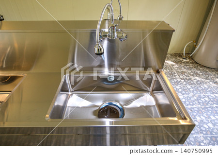 Row of Clean Stainless Steel Sinks and Faucets in a Public Facility Row of Clean Stainless Steel Sinks and Faucets in a Public Facility 140750995