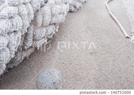 The texture of thick fiber ropes left on the sandy beach. The texture of thick fiber ropes left on the sandy beach. 140751000
