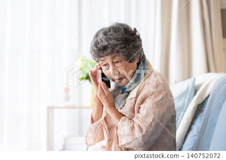 Senior woman answering a suspicious call Senior woman answering a suspicious call 140752072