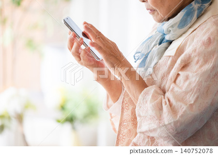 Senior woman answering a suspicious call 140752078