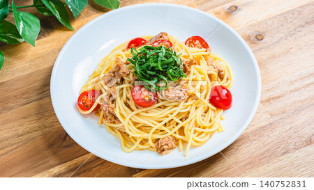 Cold pasta with tuna and cherry tomatoes, garnished with shiso leaves - a perfect summer dish. Cold pasta with tuna and cherry tomatoes, garnished with shiso leaves - a perfect summer dish. 140752831