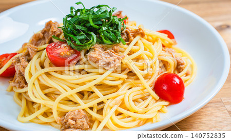 Cold pasta with tuna and cherry tomatoes, garnished with shiso leaves - a perfect summer dish. Cold pasta with tuna and cherry tomatoes, garnished with shiso leaves - a perfect summer dish. 140752835