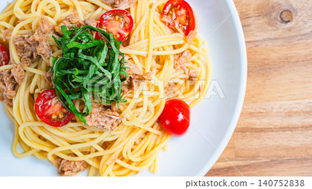 Cold pasta with tuna and cherry tomatoes, garnished with shiso leaves - a perfect summer dish. Cold pasta with tuna and cherry tomatoes, garnished with shiso leaves - a perfect summer dish. 140752838