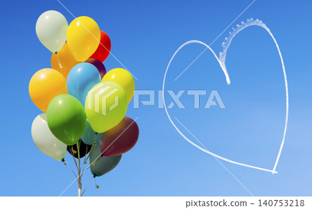 Colorful balloons and heart written in the sky by aircraft 140753218