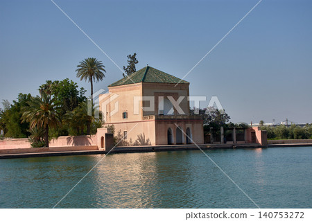 The historic Menara Gardens pavilion is reflected in the large pond under the blue Marrakech sky. The historic Menara Gardens pavilion is reflected in the large pond under the blue Marrakech sky. 140753272