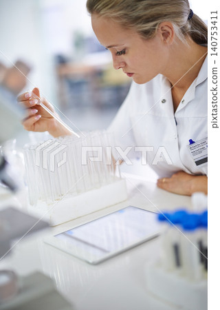 Woman, scientist and vial with test for exam, research or discovery at the laboratory. Female person or medical professional in science experiment with pipette for chemical compound or DNA study Woman, scientist and vial with test for exam, research or discovery at the laboratory. Female person or medical professional in science experiment with pipette for chemical compound or DNA study 140753411