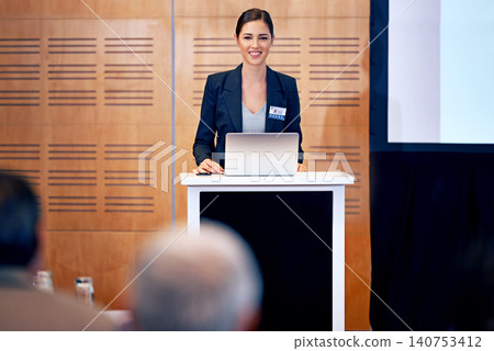 Business woman, podium and presentation with smile, conference or workshop with laptop for slideshow or PPT. Corporate training, seminar and speaker with info, audience and professional speech Business woman, podium and presentation with smile, conference or workshop with laptop for slideshow or PPT. Corporate training, seminar and speaker with info, audience and professional speech 140753412
