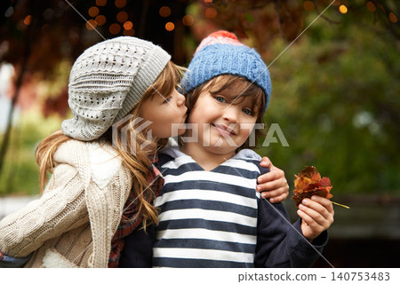 Kids, love and siblings kiss in a park for travel, adventure or bonding on autumn journey in nature. Family, support and children hug in a forest for explore, playing or fun games in Canada outdoor Kids, love and siblings kiss in a park for travel, adventure or bonding on autumn journey in nature. Family, support and children hug in a forest for explore, playing or fun games in Canada outdoor 140753483