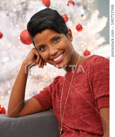 Happy, christmas and portrait of woman at her home for festive event, party or celebration. Smile, holidays and face of female person from Colombia with xmas tree on sofa in living room at apartment. Happy, christmas and portrait of woman at her home for festive event, party or celebration. Smile, holidays and face of female person from Colombia with xmas tree on sofa in living room at apartment. 140753566