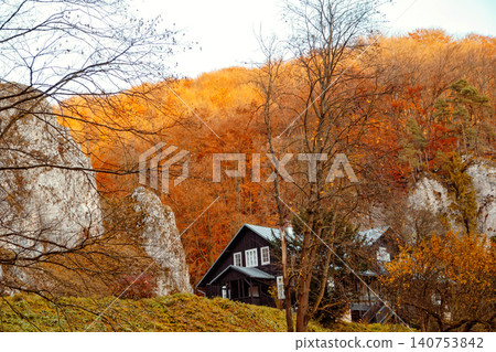 Colors of autumn frame a cabin in the hills during a sunny afternoon in the countryside Colors of autumn frame a cabin in the hills during a sunny afternoon in the countryside 140753842