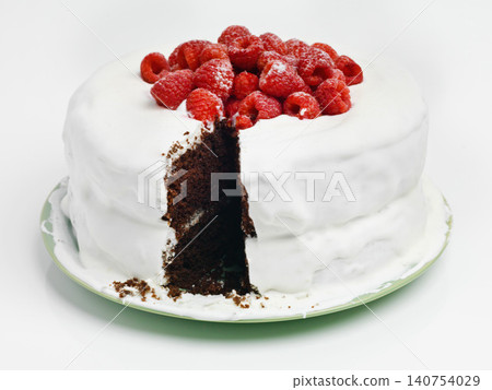 Chocolate, dessert and blackforest cake for bakery, slice and raspberries for sweet snack. Fruit, icing and plate for display on table in pastry restaurant, creamy and baked confection with berries 140754029